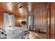 The primary bedroom features wooden walls, hardwood floors, and lots of natural light at 1112 Western Ave, Rocky Mount, NC 27804