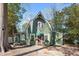 Charming green home featuring a unique roofline, complemented by a brick pathway leading to a quaint front door at 1112 Western Ave, Rocky Mount, NC 27804