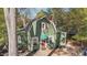 Charming green home featuring a unique roofline, complemented by a brick pathway leading to a quaint front door at 1112 Western Ave, Rocky Mount, NC 27804