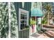 Charming green exterior with a window box, awning, and brick walkway creating curb appeal at 1112 Western Ave, Rocky Mount, NC 27804