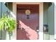 Charming front door with decorative hardware and inviting signage with a fern hanging to the side at 1112 Western Ave, Rocky Mount, NC 27804