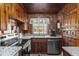 Charming kitchen features wooden walls and cabinets, granite countertops, and modern appliances at 1112 Western Ave, Rocky Mount, NC 27804