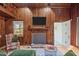 Cozy living area with wood-paneled walls, fireplace, TV, and an open layout with comfortable seating at 1112 Western Ave, Rocky Mount, NC 27804
