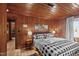 The main bedroom features hardwood floors, warm wood walls, and a passage to another room at 1112 Western Ave, Rocky Mount, NC 27804