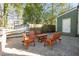 Charming brick patio area with wooden chairs and table set perfect for outdoor entertaining at 1112 Western Ave, Rocky Mount, NC 27804