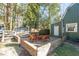 Charming brick patio area with wooden chairs and table set perfect for outdoor entertaining at 1112 Western Ave, Rocky Mount, NC 27804