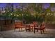 Inviting brick patio with wooden furniture set illuminated by string lights at dusk at 1112 Western Ave, Rocky Mount, NC 27804