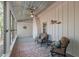 Bright sunroom with white brick accents, a metal ceiling, large windows, and comfortable seating at 1112 Western Ave, Rocky Mount, NC 27804