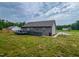 View of home exterior with wooden deck and green lawn at 112 Tillburg Ln, Hurdle Mills, NC 27541