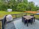 Inviting outdoor deck perfect for dining with BBQ, overlooking spacious green backyard at 112 Tillburg Ln, Hurdle Mills, NC 27541