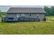 Spacious backyard featuring an accessible ramp leading to a deck and a well-maintained lawn at 112 Tillburg Ln, Hurdle Mills, NC 27541