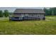 Exterior of home featuring ramp access to deck and spacious backyard at 112 Tillburg Ln, Hurdle Mills, NC 27541