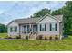 Charming single-story home featuring a covered front porch and manicured lawn at 112 Tillburg Ln, Hurdle Mills, NC 27541