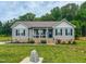 Quaint front exterior of a home with a well-maintained lawn and inviting porch at 112 Tillburg Ln, Hurdle Mills, NC 27541