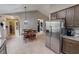 Open concept kitchen and dining area with stainless steel refrigerator and four-seat dining table at 112 Tillburg Ln, Hurdle Mills, NC 27541