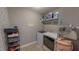 Functional laundry room with modern washer/dryer, storage shelves, and neutral walls at 112 Tillburg Ln, Hurdle Mills, NC 27541