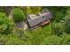 Aerial view of a home with a wooden deck surrounded by meticulously manicured lawn and mature trees at 113 Denard St, Oxford, NC 27565