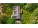 Aerial view of a home showcasing its expansive backyard, deck, and surrounding greenery at 113 Denard St, Oxford, NC 27565