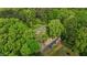 Stunning aerial view of a home nestled among lush green trees and a winding driveway at 113 Denard St, Oxford, NC 27565