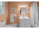 Well-lit bathroom with a single sink vanity, a white shower curtain, and neutral wall paint at 113 Denard St, Oxford, NC 27565