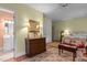Bright bedroom featuring a dresser with lamps, a bed, and a view into an adjacent bathroom at 113 Denard St, Oxford, NC 27565