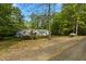 Well-maintained single-story house surrounded by lush trees, bushes and green grass at 113 Denard St, Oxford, NC 27565