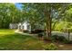 Charming single-story home with a well-maintained lawn, lush landscaping, and a driveway at 113 Denard St, Oxford, NC 27565