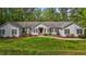 Charming single-story home with manicured front lawn and mature trees at 113 Denard St, Oxford, NC 27565