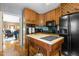 View of the kitchen featuring wooden cabinets, black appliances and butcher block island at 113 Denard St, Oxford, NC 27565