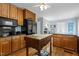 Kitchen with a center butcher block island, wooden cabinets, and black appliances at 113 Denard St, Oxford, NC 27565