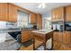 Traditional-style kitchen features wooden cabinets, granite countertops, an island, and a view to a breakfast nook at 113 Denard St, Oxford, NC 27565