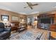 Inviting living room with leather furniture, a large rug, and a built-in entertainment center at 113 Denard St, Oxford, NC 27565