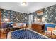 Cozy living room featuring floral wallpaper, blue accents, and stylish furniture at 113 Denard St, Oxford, NC 27565