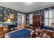 Elegant blue living room featuring floral wallpaper, hardwood floors, and period furnishings at 113 Denard St, Oxford, NC 27565