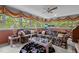 Bright sunroom with large windows, floral sofas, and ceiling fan at 113 Denard St, Oxford, NC 27565