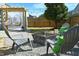 Backyard lounge area with a cozy seating around a fire pit and stylish hanging egg chairs at 1145 Raven Perch Dr, Wendell, NC 27591