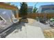 Landscaped backyard featuring a covered patio with egg chairs and fire pit area at 1145 Raven Perch Dr, Wendell, NC 27591