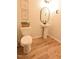 Cozy bathroom featuring a pedestal sink, framed wall art, and a toilet with decorative accents at 1145 Raven Perch Dr, Wendell, NC 27591