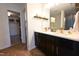 Bathroom boasts black vanity with double sinks, modern fixtures, and herringbone wood-look floors at 1145 Raven Perch Dr, Wendell, NC 27591
