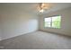 Spacious bedroom with plush carpeting, ceiling fan, and a large window for ample natural light at 1145 Raven Perch Dr, Wendell, NC 27591