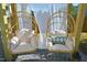 Close up of two hanging egg chairs with white cushions and a decorated pillow at 1145 Raven Perch Dr, Wendell, NC 27591