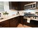 Modern kitchen features stainless steel appliances, stone countertops, and wood cabinets at 1145 Raven Perch Dr, Wendell, NC 27591