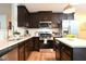 Modern kitchen with stainless steel appliances, dark wood cabinets, and ample counter space at 1145 Raven Perch Dr, Wendell, NC 27591