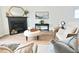 Inviting living room with a black fireplace, a stylish mirror, and cozy seating arrangements at 1145 Raven Perch Dr, Wendell, NC 27591
