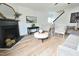 Bright living room with a black fireplace, mantel mirror, and wood-look flooring at 1145 Raven Perch Dr, Wendell, NC 27591