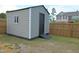 Backyard shed with a black door and ramp at 1145 Raven Perch Dr, Wendell, NC 27591