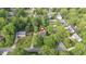 Aerial view of a charming home nestled among lush trees with mature landscaping and quiet surroundings at 1207 Candlewood Dr, Elon, NC 27244