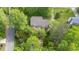 Aerial view showcasing the home and surrounding lush trees in a quiet neighborhood at 1207 Candlewood Dr, Elon, NC 27244