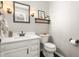 Updated bathroom featuring a vanity, framed mirror, sconces, and wood-look accents at 1207 Candlewood Dr, Elon, NC 27244