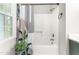 Clean bathroom featuring shower with decorative shower curtain, with a window providing natural light at 1207 Candlewood Dr, Elon, NC 27244